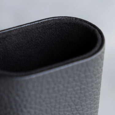 Detail photo showing the black leather exterior and notte Alcantara interior lining of the Charles Simon Oscar Watch roll
